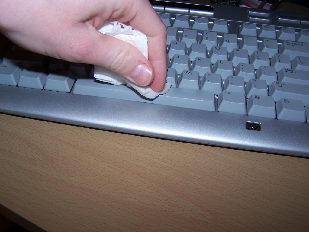 wiping the keyboard with an alcohol pad
