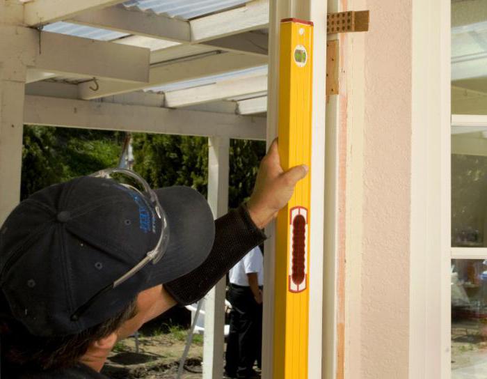 installation of metal entrance doors with your hands in a wooden house
