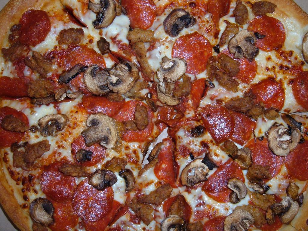 Pizza with mushrooms, sausage and cheese
