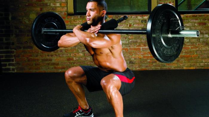 squat with a barbell on his chest as right