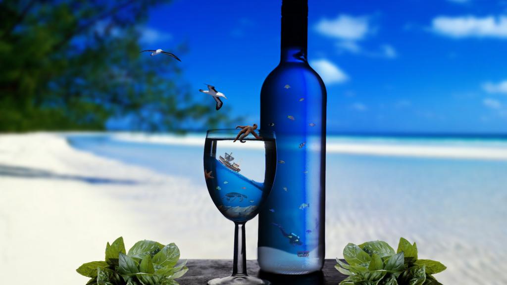 Bottle and glass on a sea background